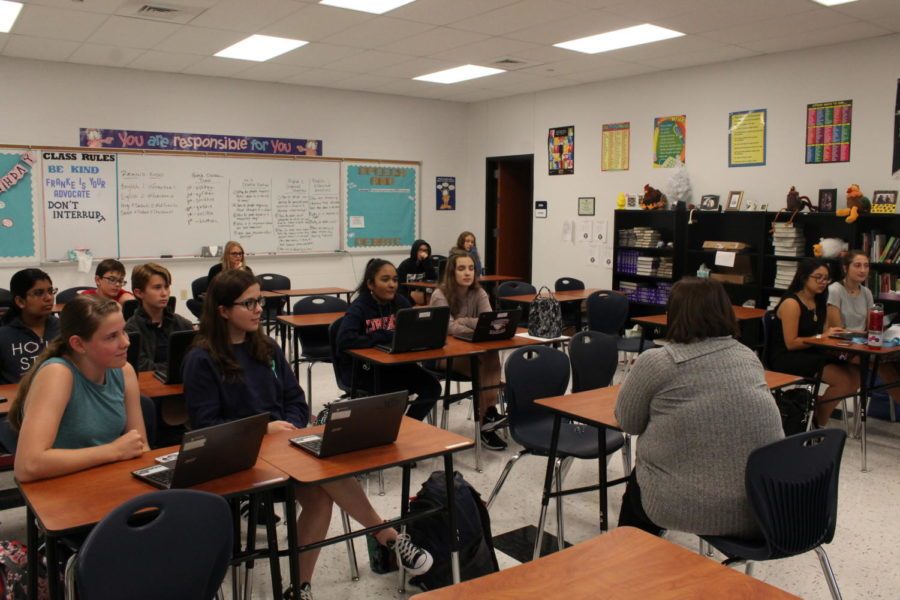 Students working on laptops during a practice session